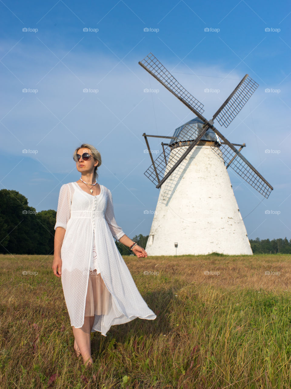 Fashionable woman standing against windmill
