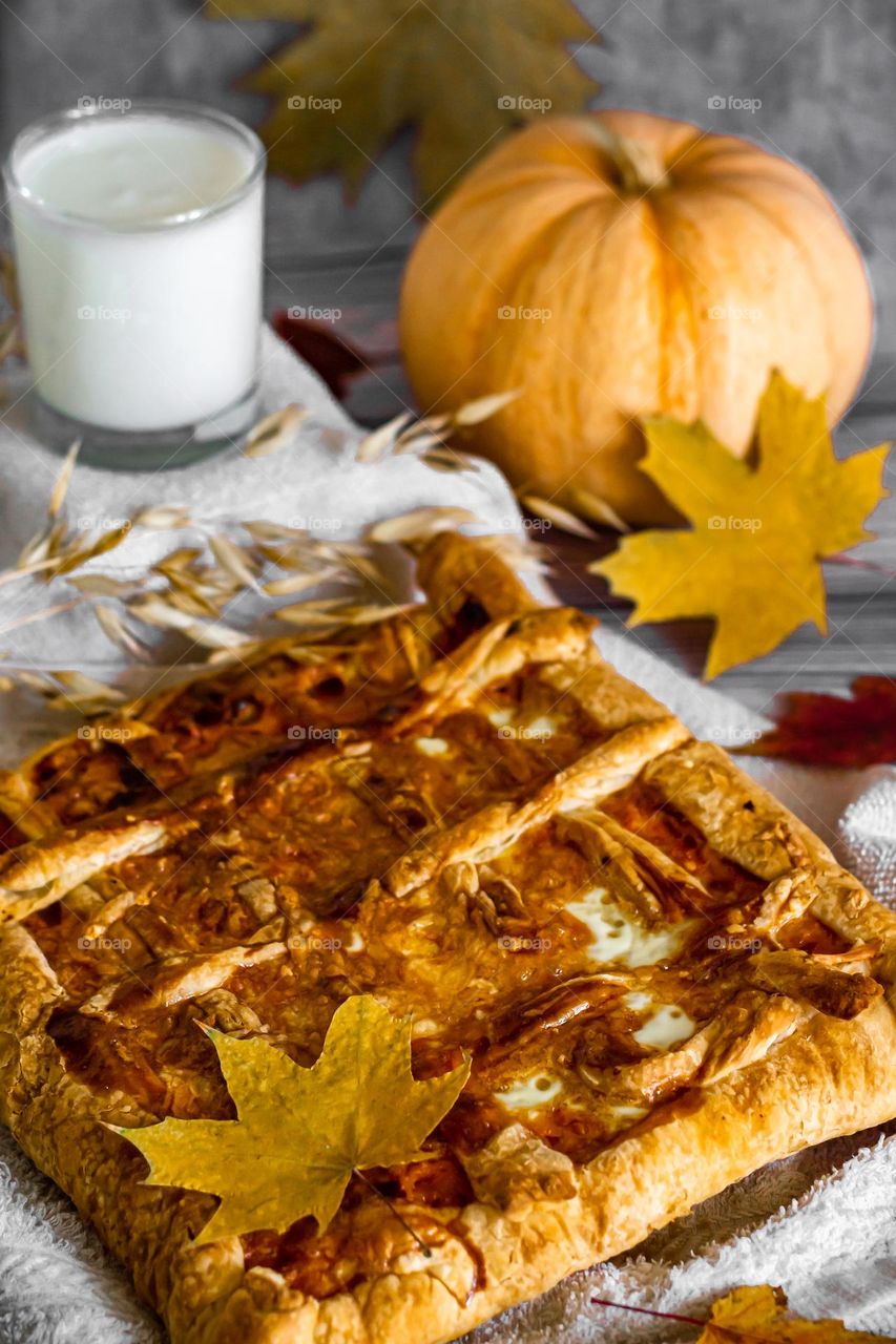 Food still life pumpkin season, pumpkin homemade pie and glass of milk on gray background