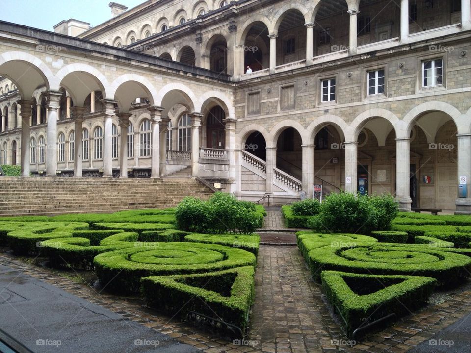 Arches and hedge at heritage building
