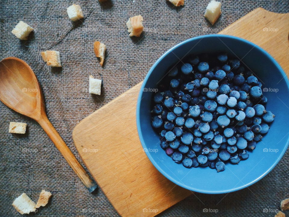 frozen currants, bread crumbs and a wooden spoon on the table