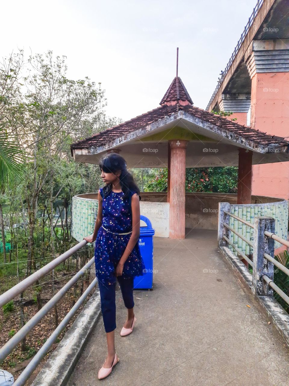 Girl standing on a bridge