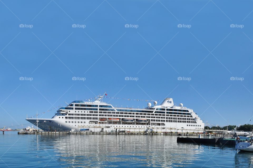 A cruise ship sits docked at a pier off the Puget sound of West Seattle, Washington.