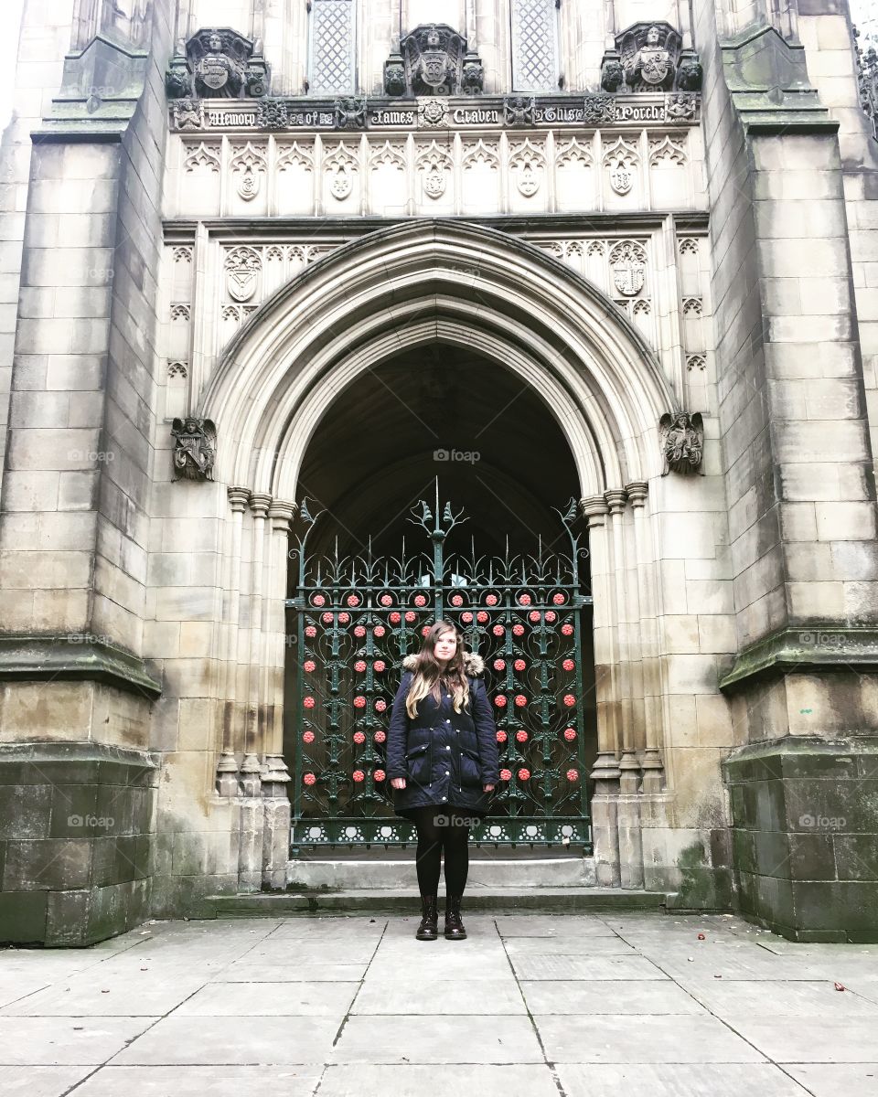Girl/woman standing outside Manchester Cathedral