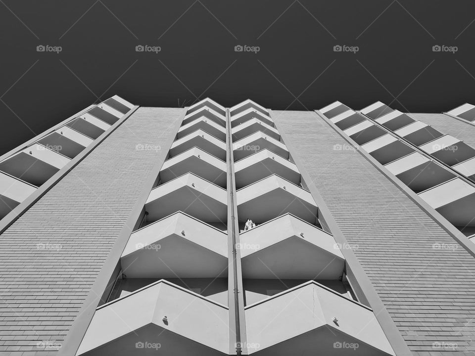 facade of a building with balconies in black and white
