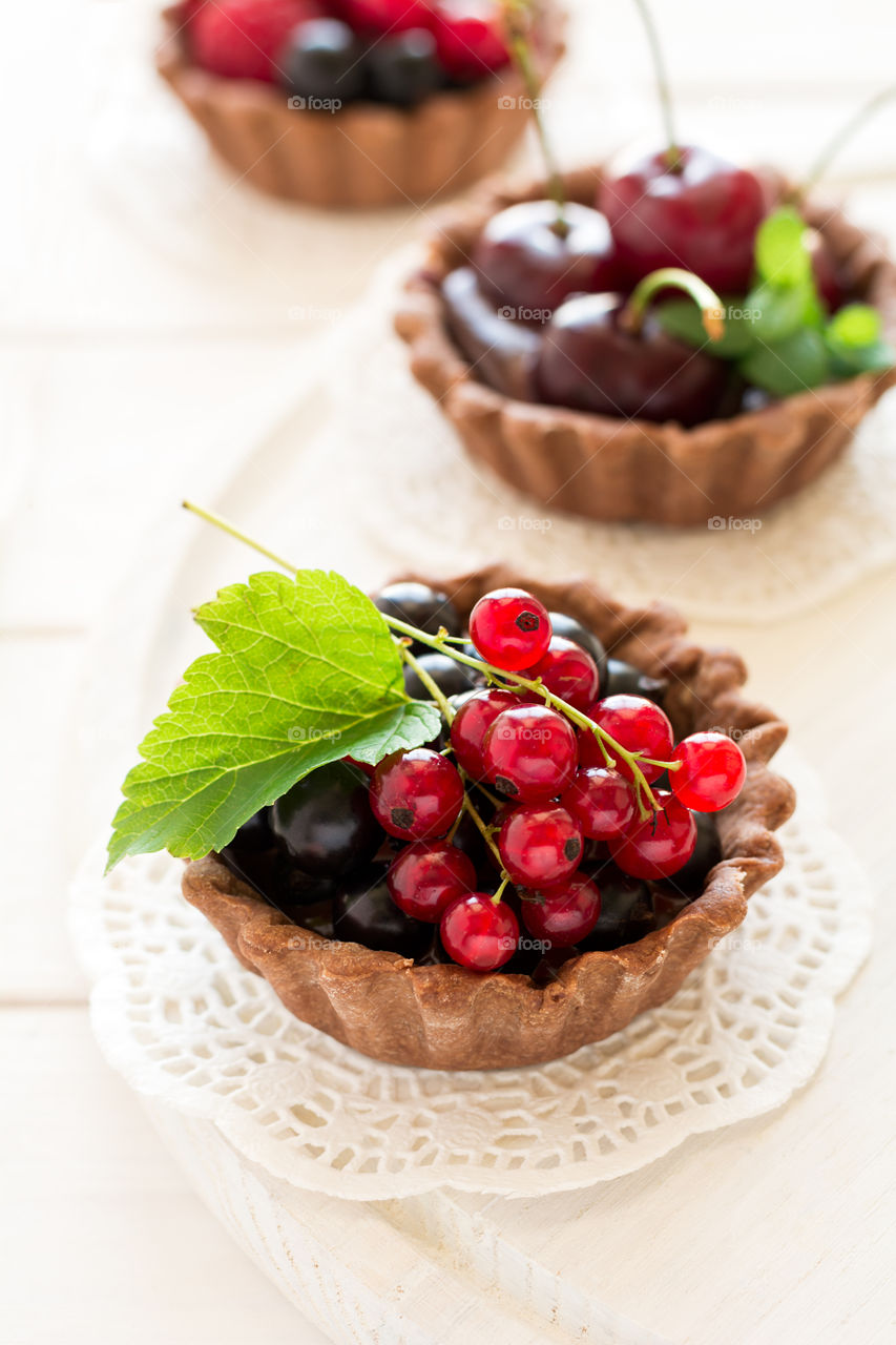 Homemade chocolate mini tarts with berries