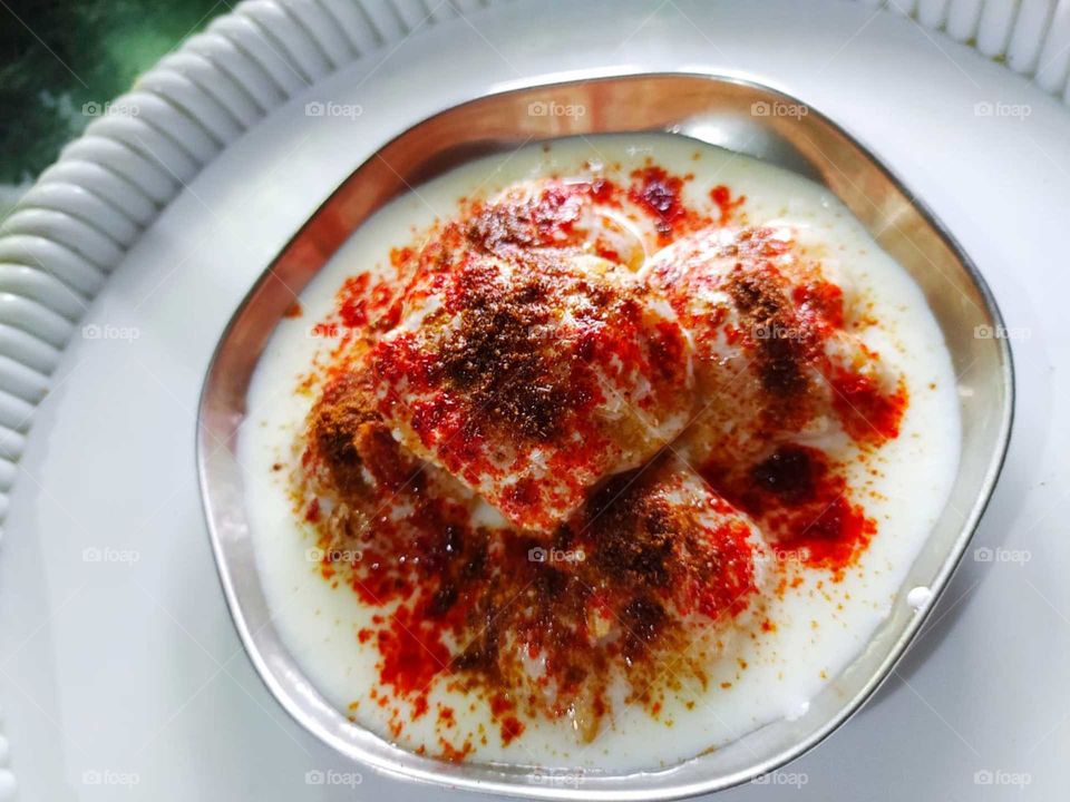Dahi vada is a type of chaat originating from the Indian subcontinent and popular throughout South Asia. It is prepared by soaking vadas in thick dahi.