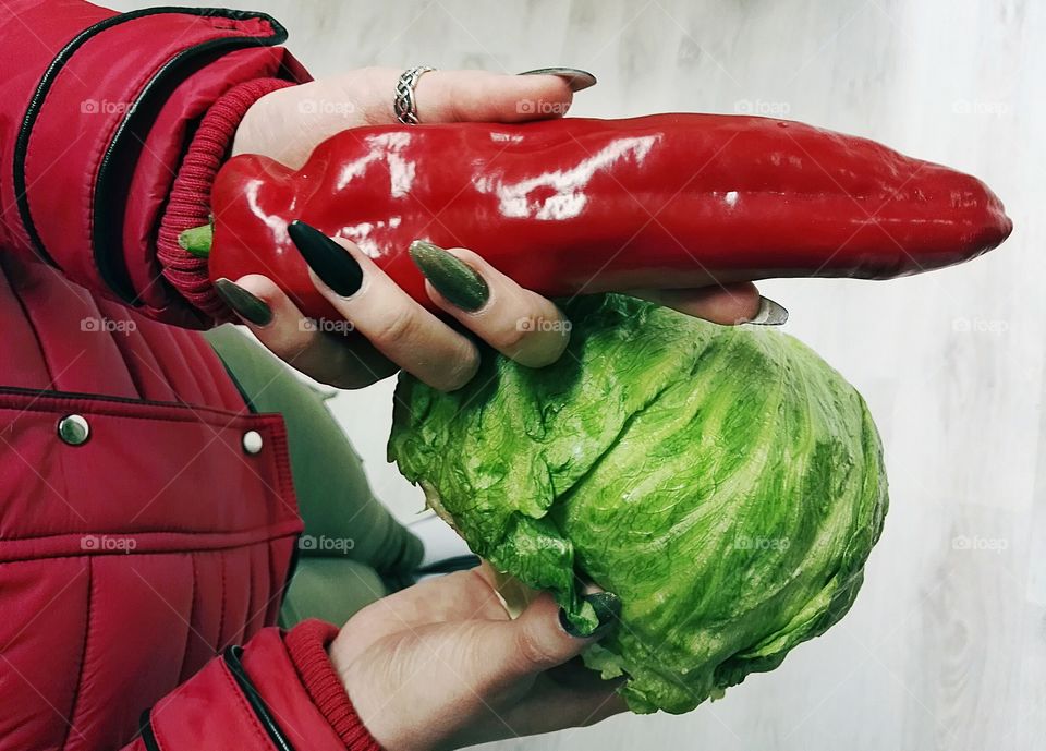 holding green lettuce and red pepper