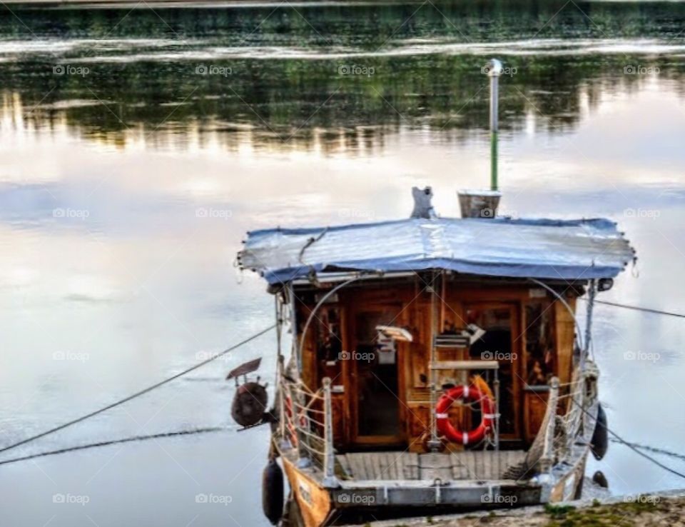 Small ferry boat at dusk on the shores of the Loire