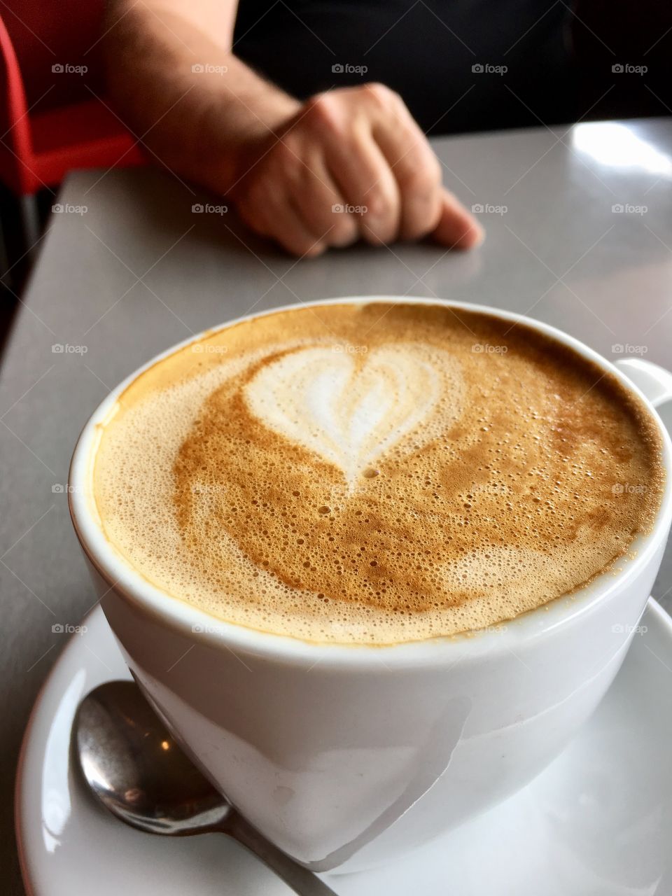 Coffee latte in white coffee cup on table 