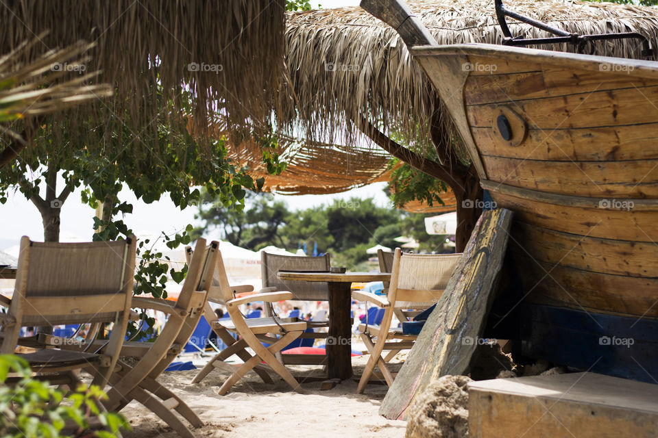 cafe bar on beach. cafe bar with cane parasols and wooden chairs on beach