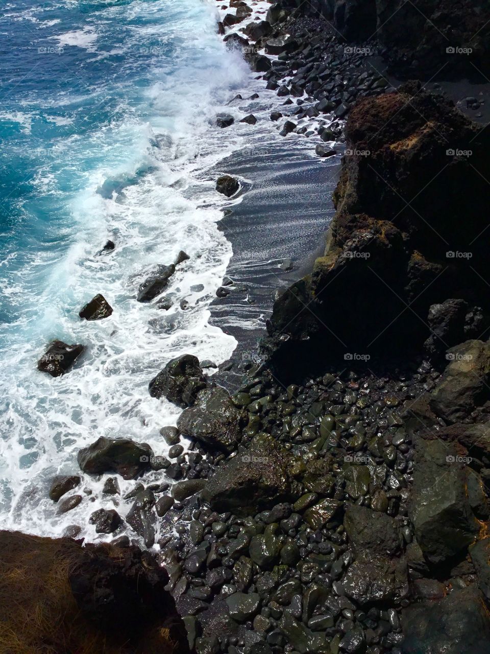 Wave on a black sand beach