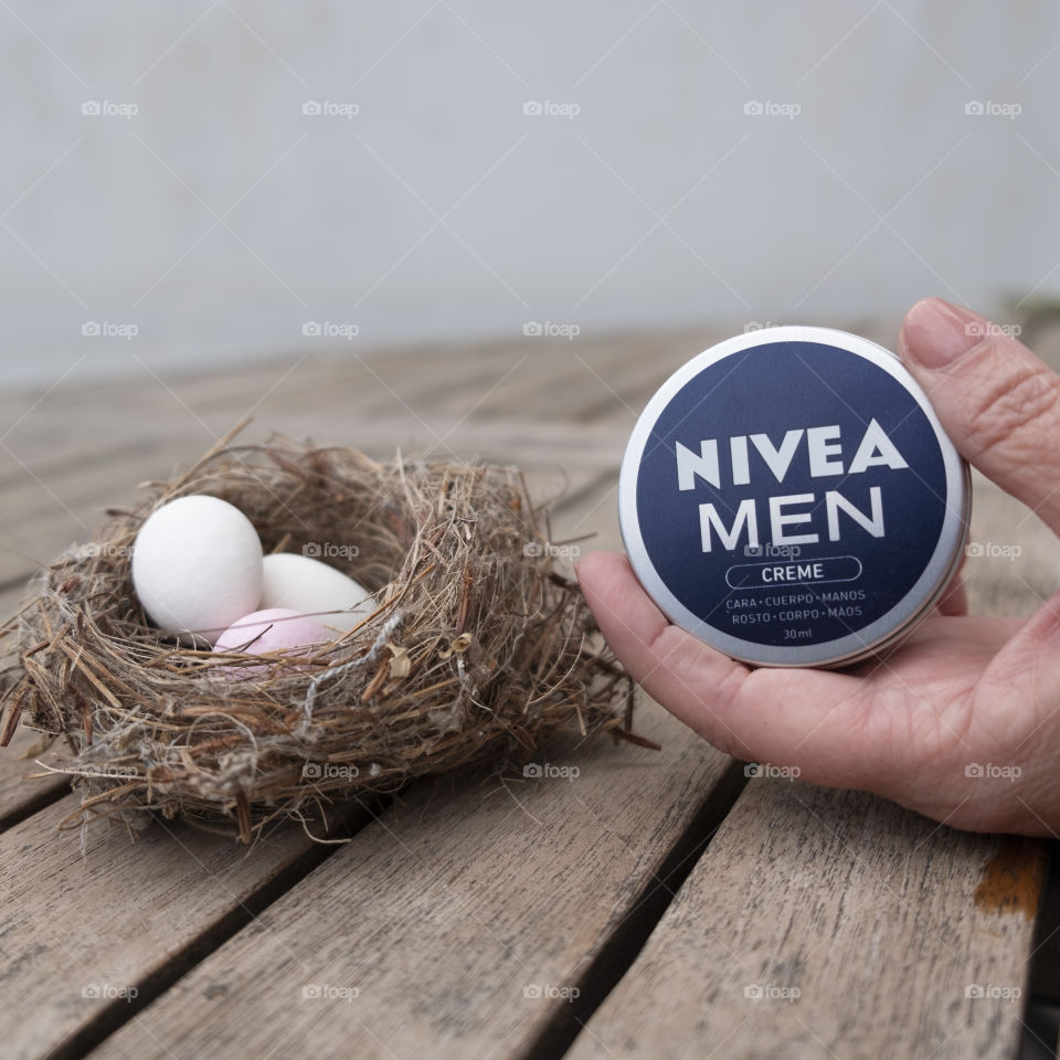 Nest with Easter eggs and someone handling a Nivea tin for men