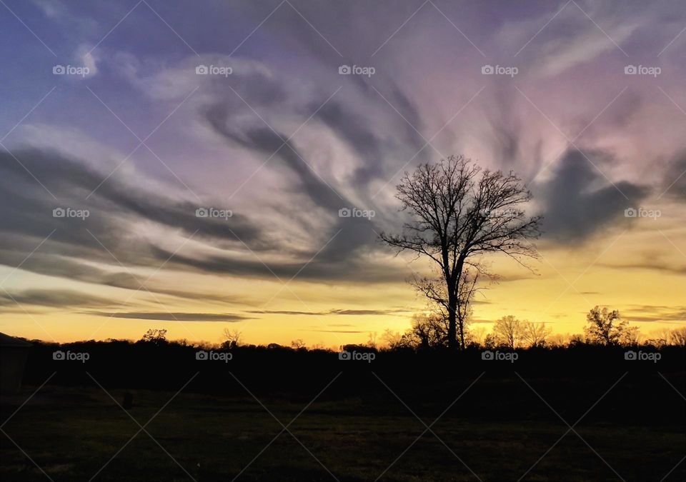 Swirly clouds with sunset