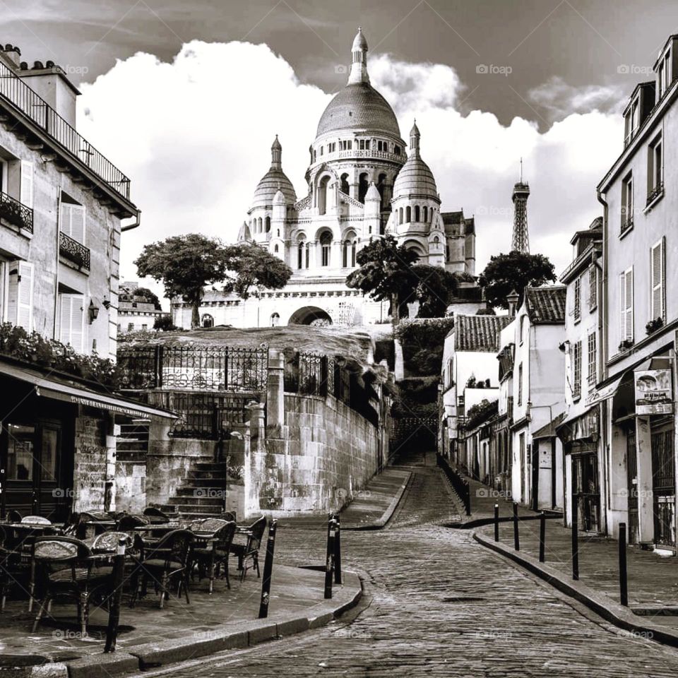 Vintage black and white shot of the Sacred-Heart Basilica from a paved street below