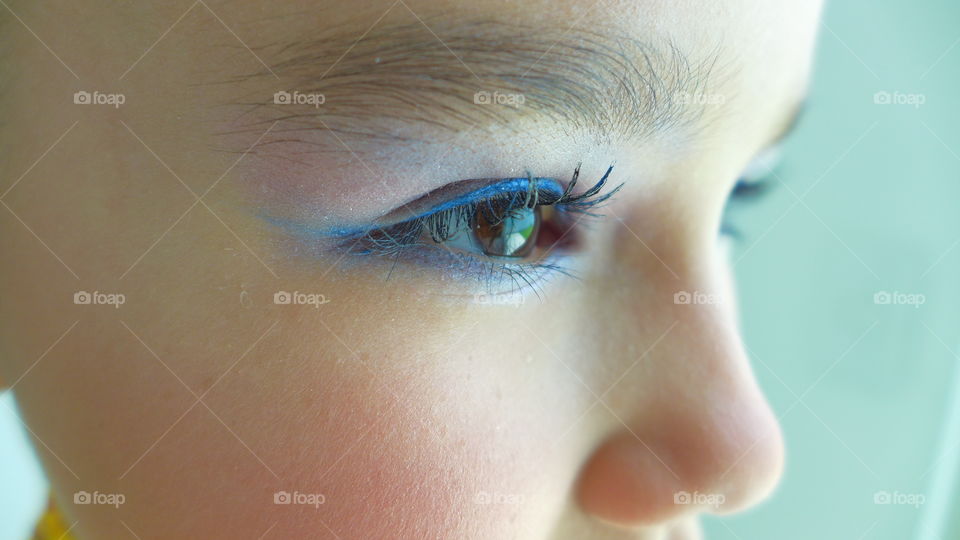 Young girl eye makeup closeup. Eye detail showing a little girl wearing makeup for a dance festival