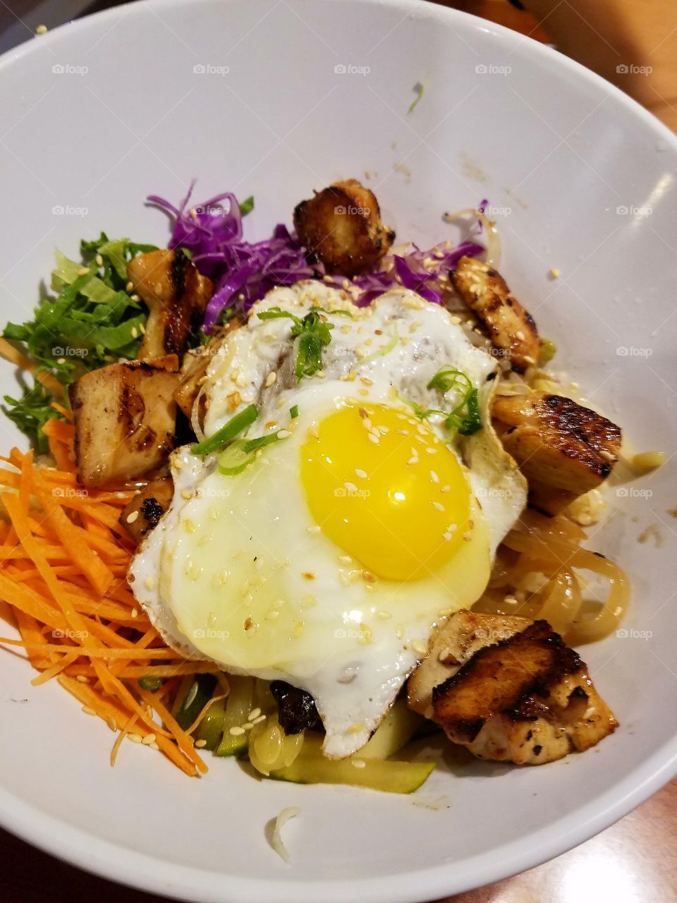 chicken, rice and vegetables bowl top with eggs