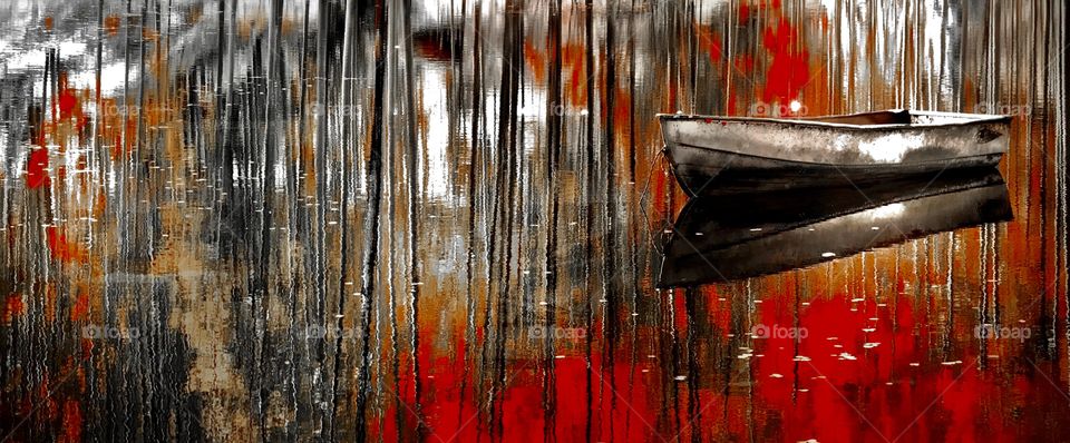 Raft floating over water with the reflection of fall