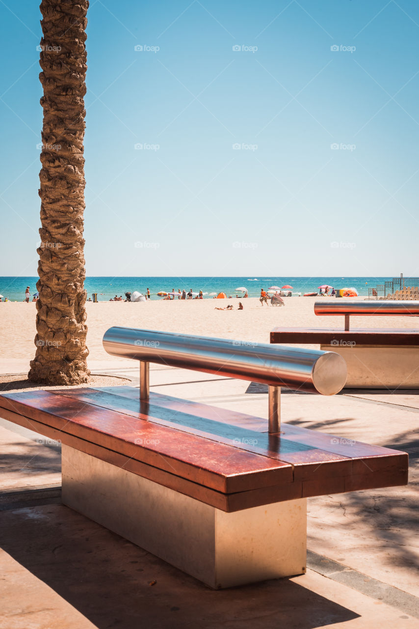 Bench of the beach in a summer day