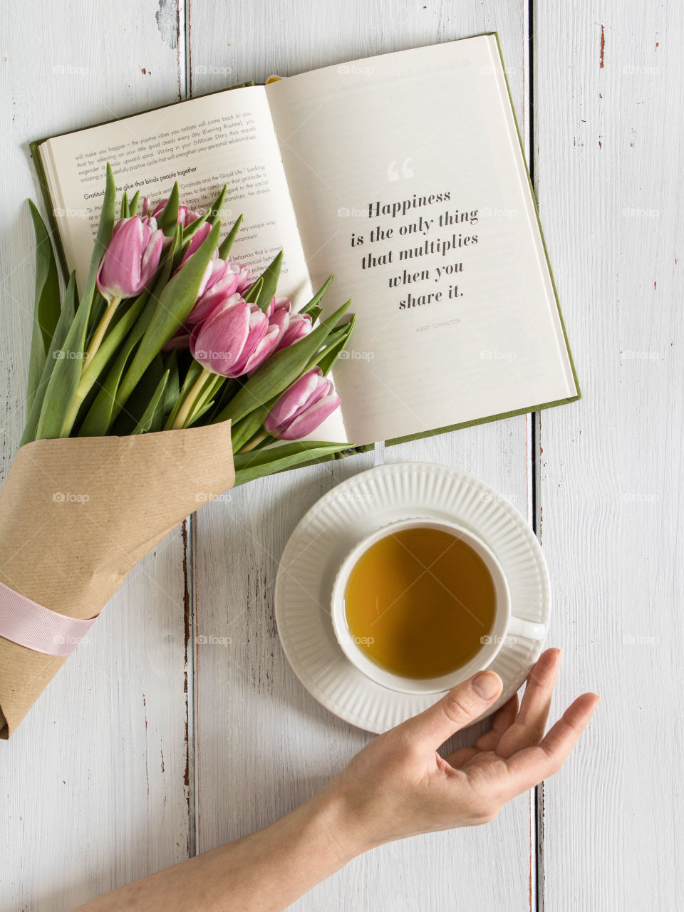 drinking tea and reading book, pink flowers, white wooden table