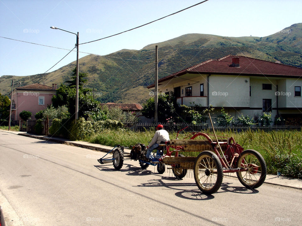Man driving land vehicle on street
