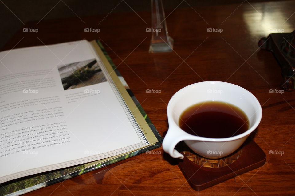 Coffee time reading an interesting and colorful book 