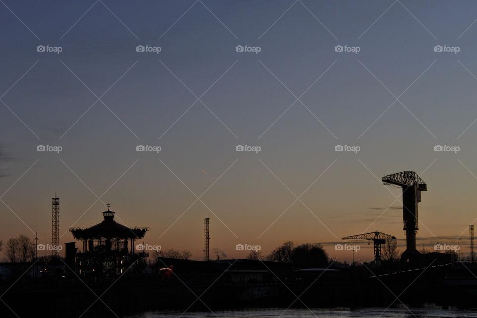 Skyline with carousel and giant crane