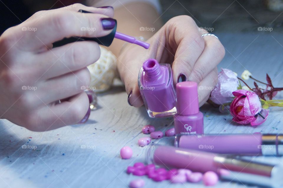 woman paints her nails with varnish