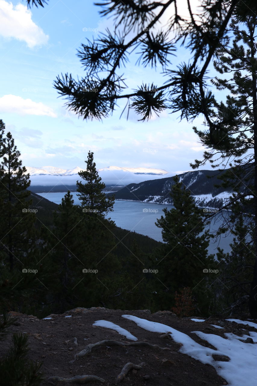 Autumn at the lake in the mountains surrounded by pines.