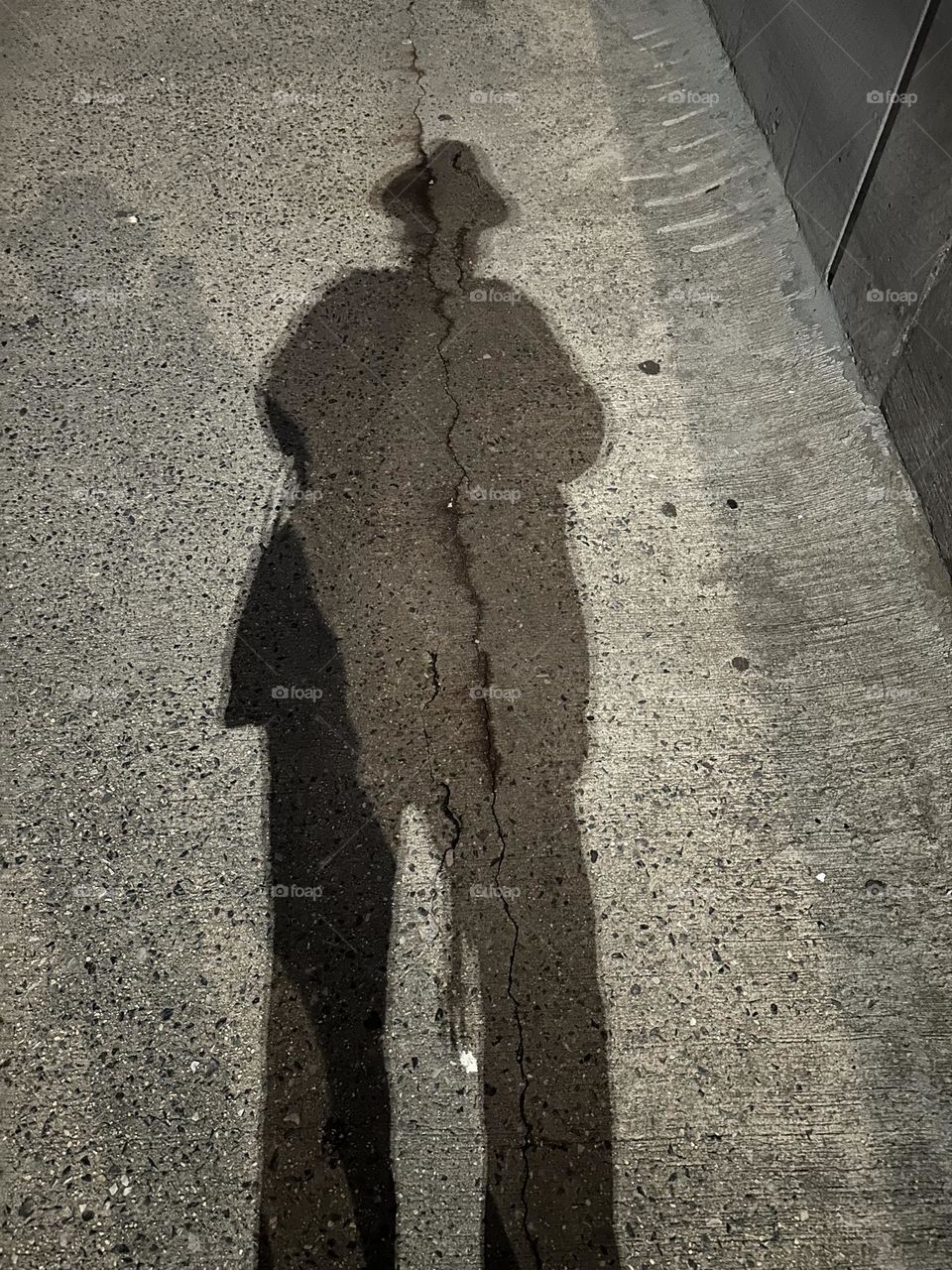 A very theatrical shadow emerges when the nighttime illumination of the pedestrian lane on the “Pulaski Bridge” at “Newtown Creek” hits an object such as myself standing there. The bridge connects LIC to “Greenpoint”, Bklyn. 2023 Hypnotic Productions