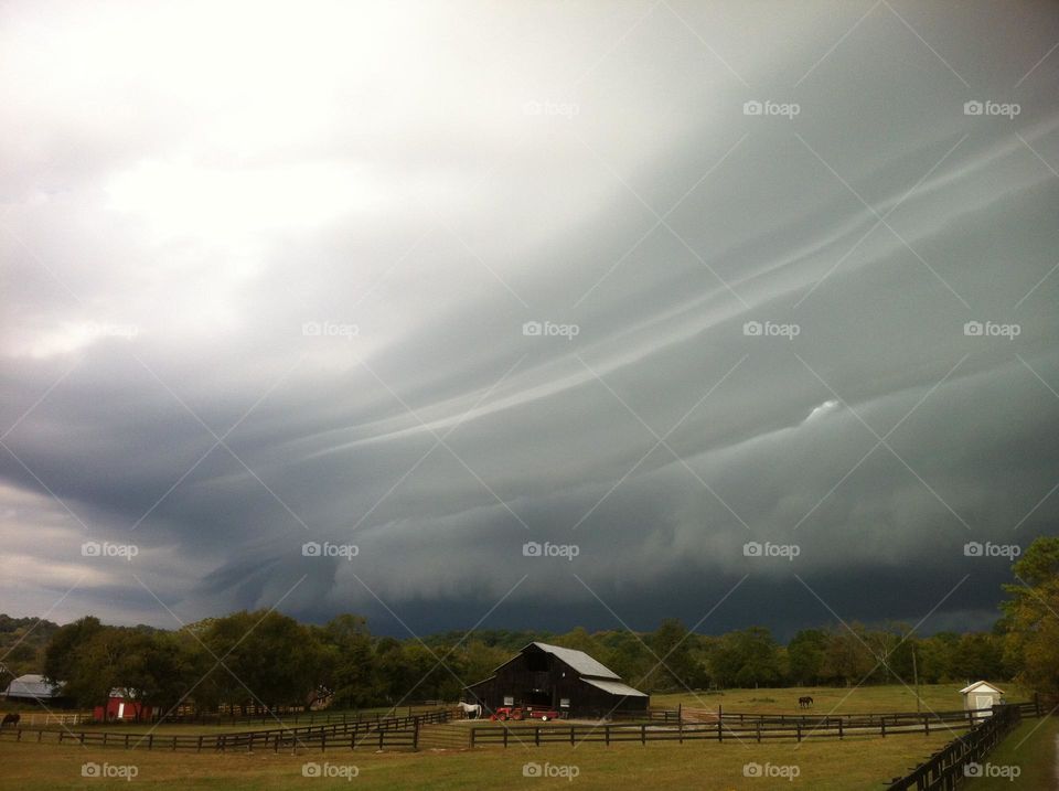 Rain storm clouds sky over country countryside farm horse barn fields paddocks Tennessee summer vacation weather rural