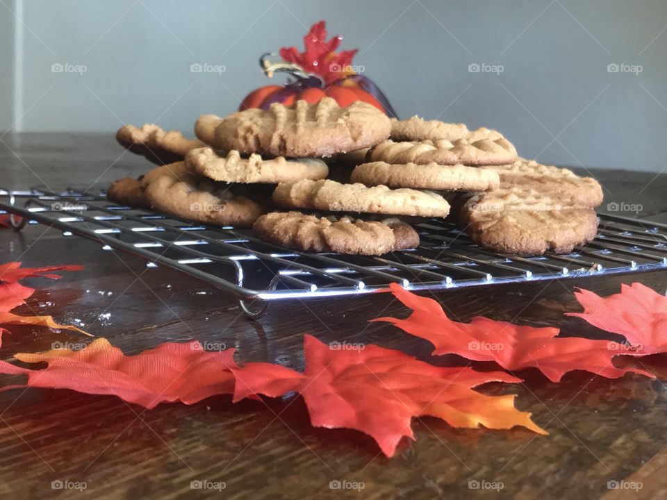 Peanut Butter Cookies on a Cooling Rack  on a Table Surrounded by Maple Leaves 