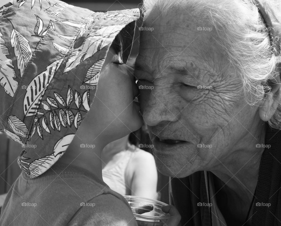 boy kissing great grandmother