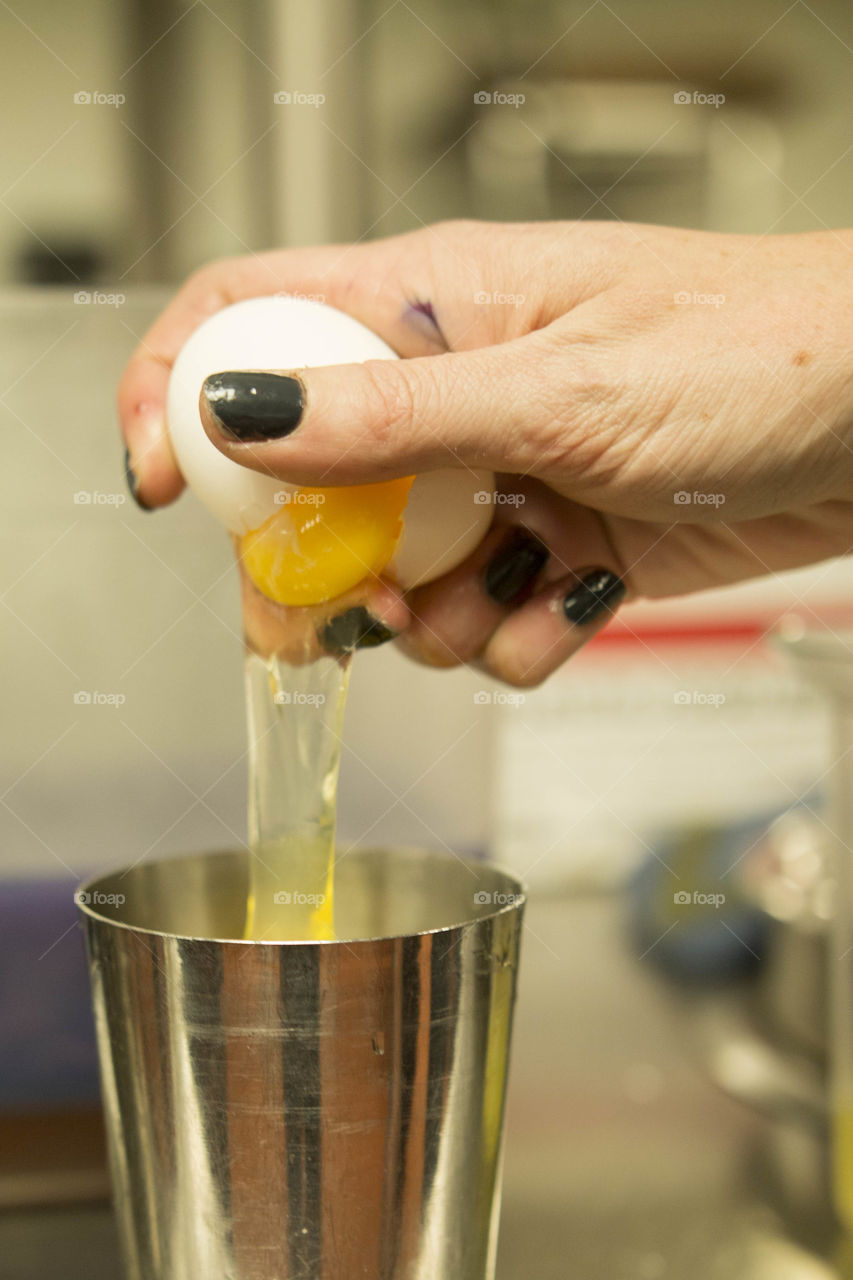 Cracking egg into drink