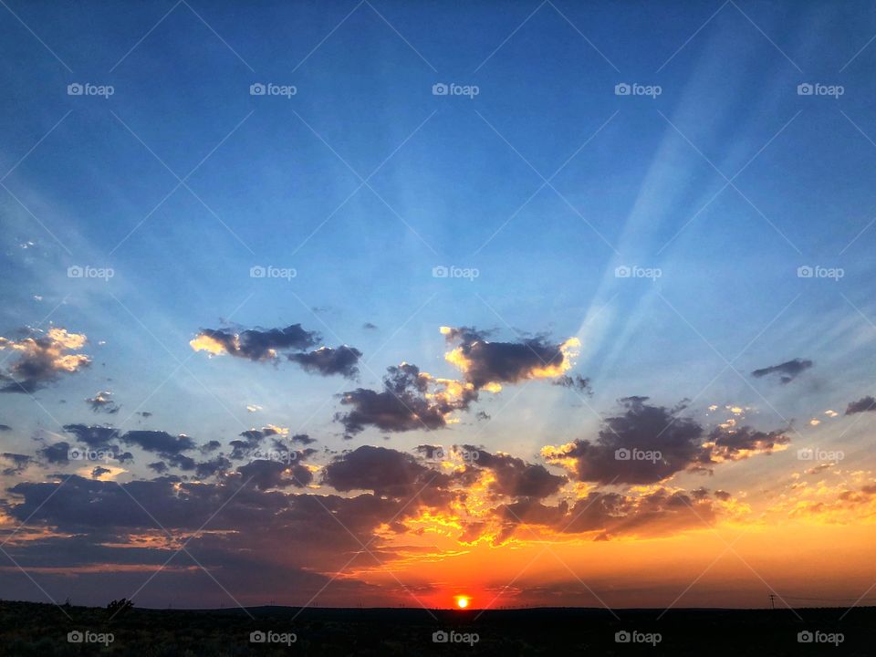 Brilliant sunset, clouds and bright blue sky