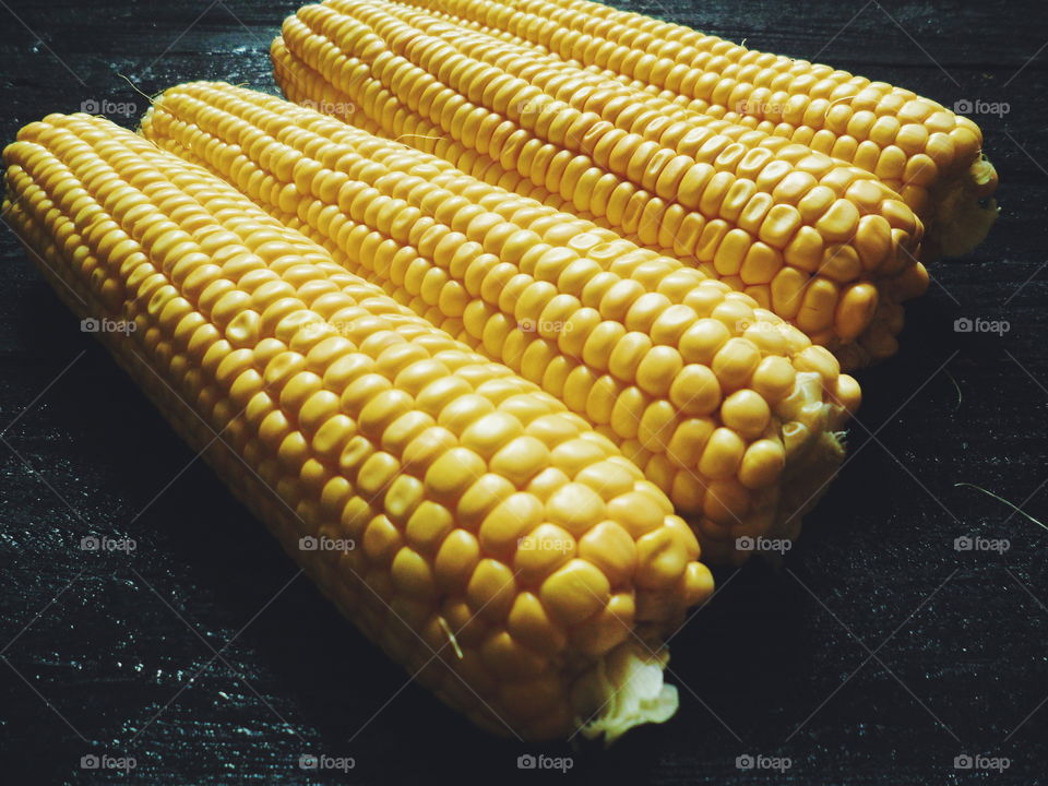 yellow corn on black, vegetables