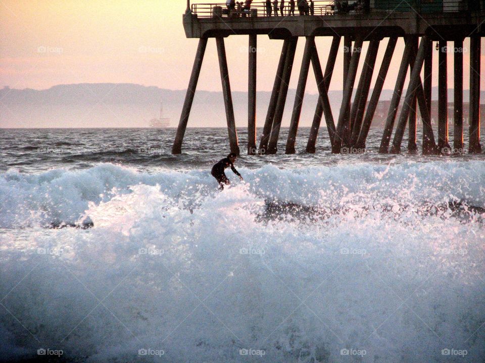 Surfing in Winter. Surfer in Huntington Beach, California