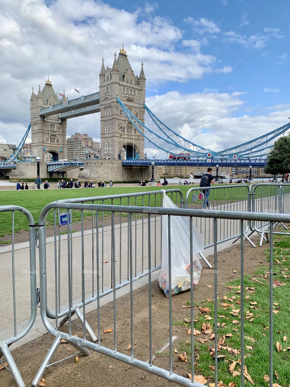London U.K. Thursday 15th September, 2022. A rubbish bag is tied to railings which form barriers to manage the queue to see the late Queen Elizabeth II Lying-in-State. Tower Bridge is in the background.