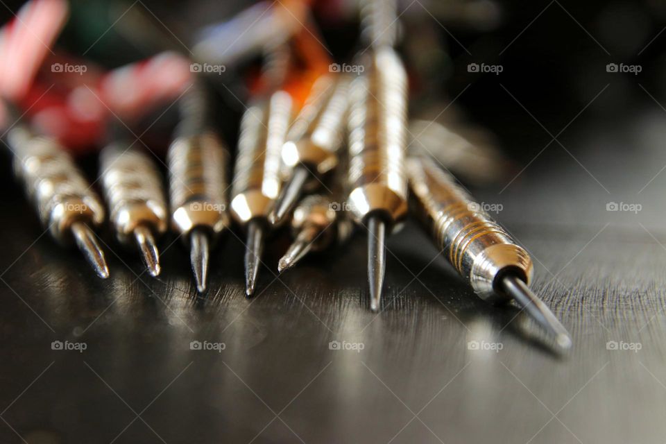 Close-up of darts lying on a table