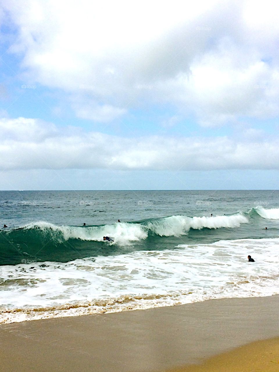Shoreline, surfers 🏄 and ☁️ 