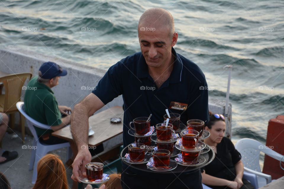 Peddler of tea front of the Maiden's Tower, Kiz Kulesi, Istanbul, Turkey