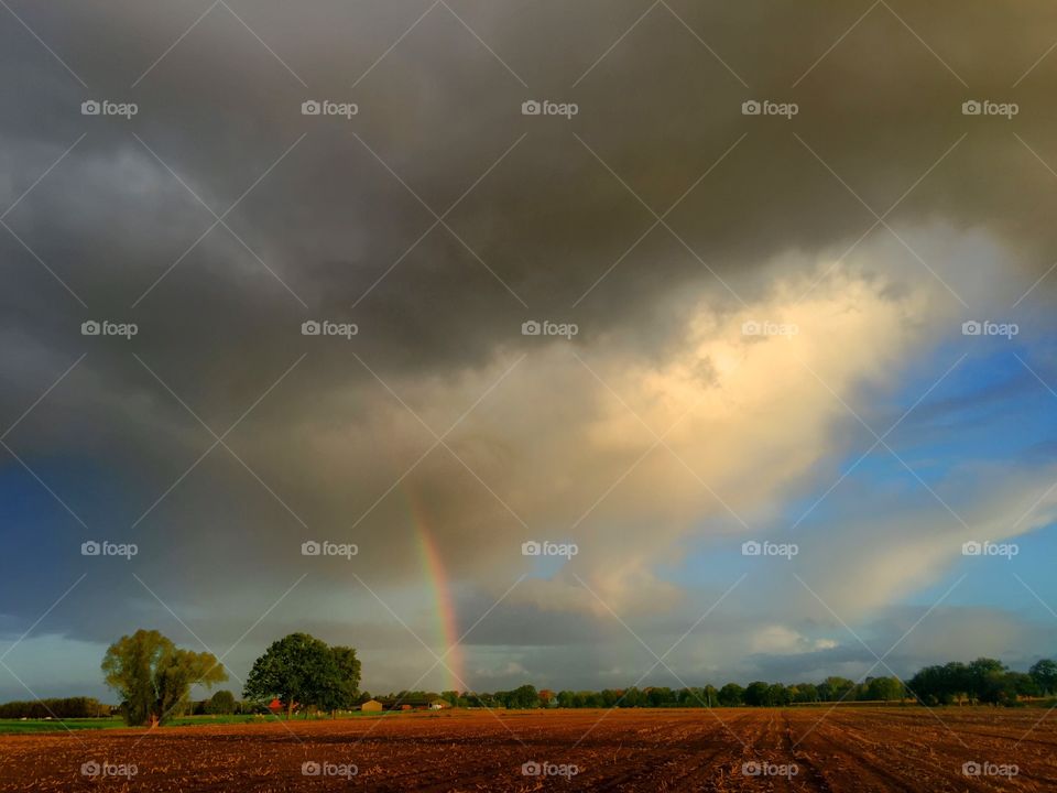 Dramatic Sky and rainbow over The farmfields