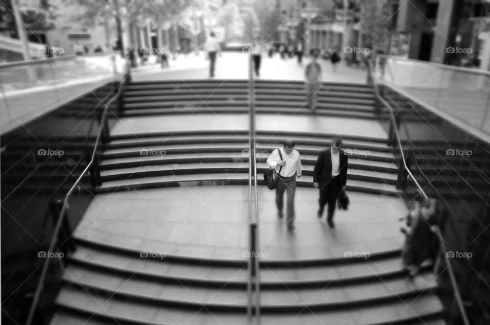 Two businessmen walking down the stairs