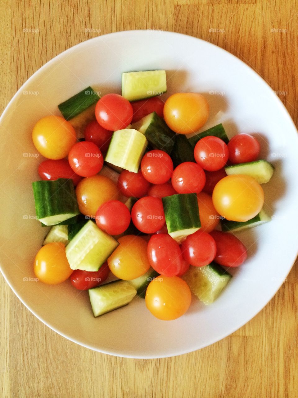 Cucumbers and tomatoes in a bowl. Cucumbers and tomatoes in a bowl
