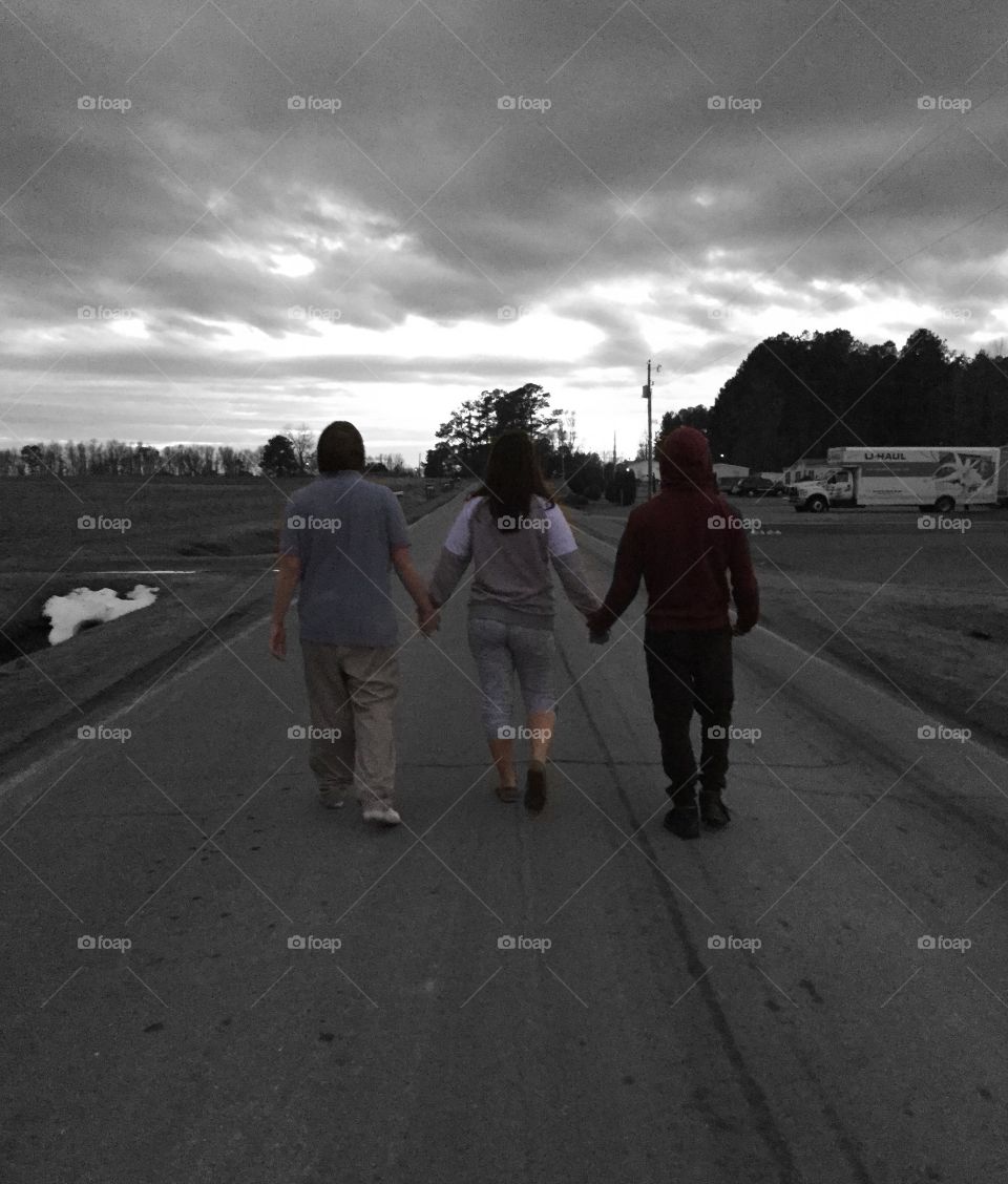 Three friends walking down the road