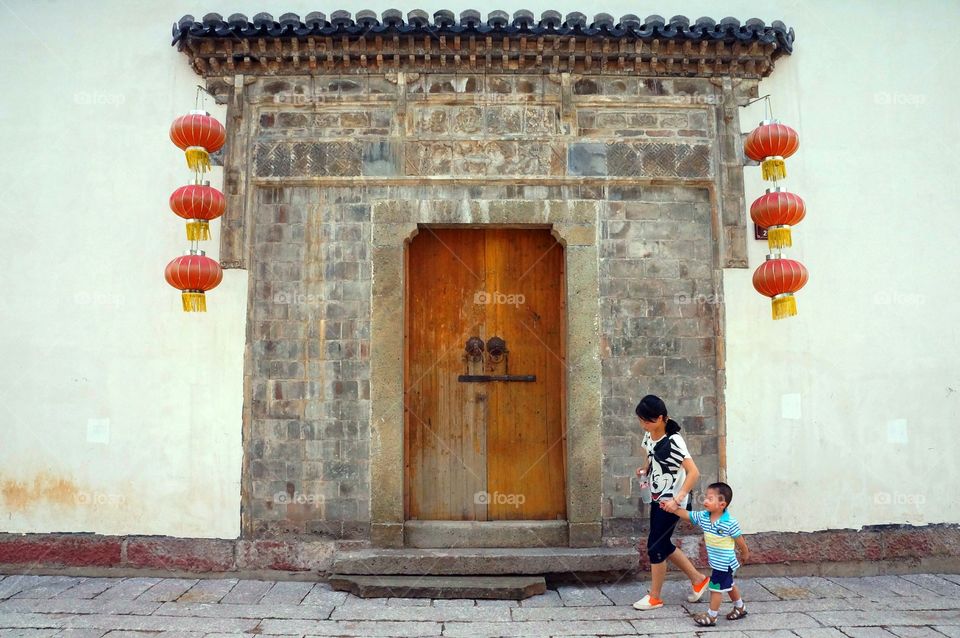 Let's Go My Child.. This heartwarming photo of a mother and child  was captured during my first travel adventure in Jinhua.