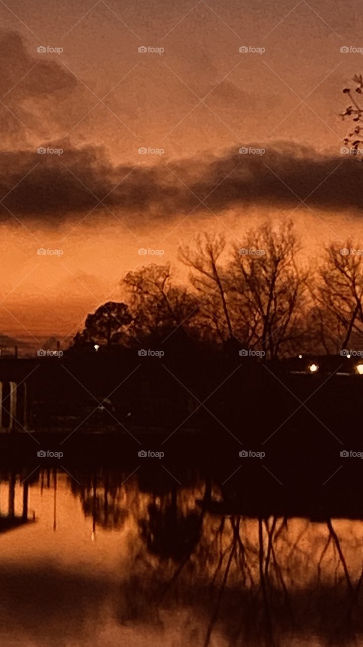 Twilight Full Bore. Massive Overcasting Shadows Bringing in Big Bright Evening Colors of Yellows, Oranges, and Deep Grays At Horizon Level on the Way to Night.