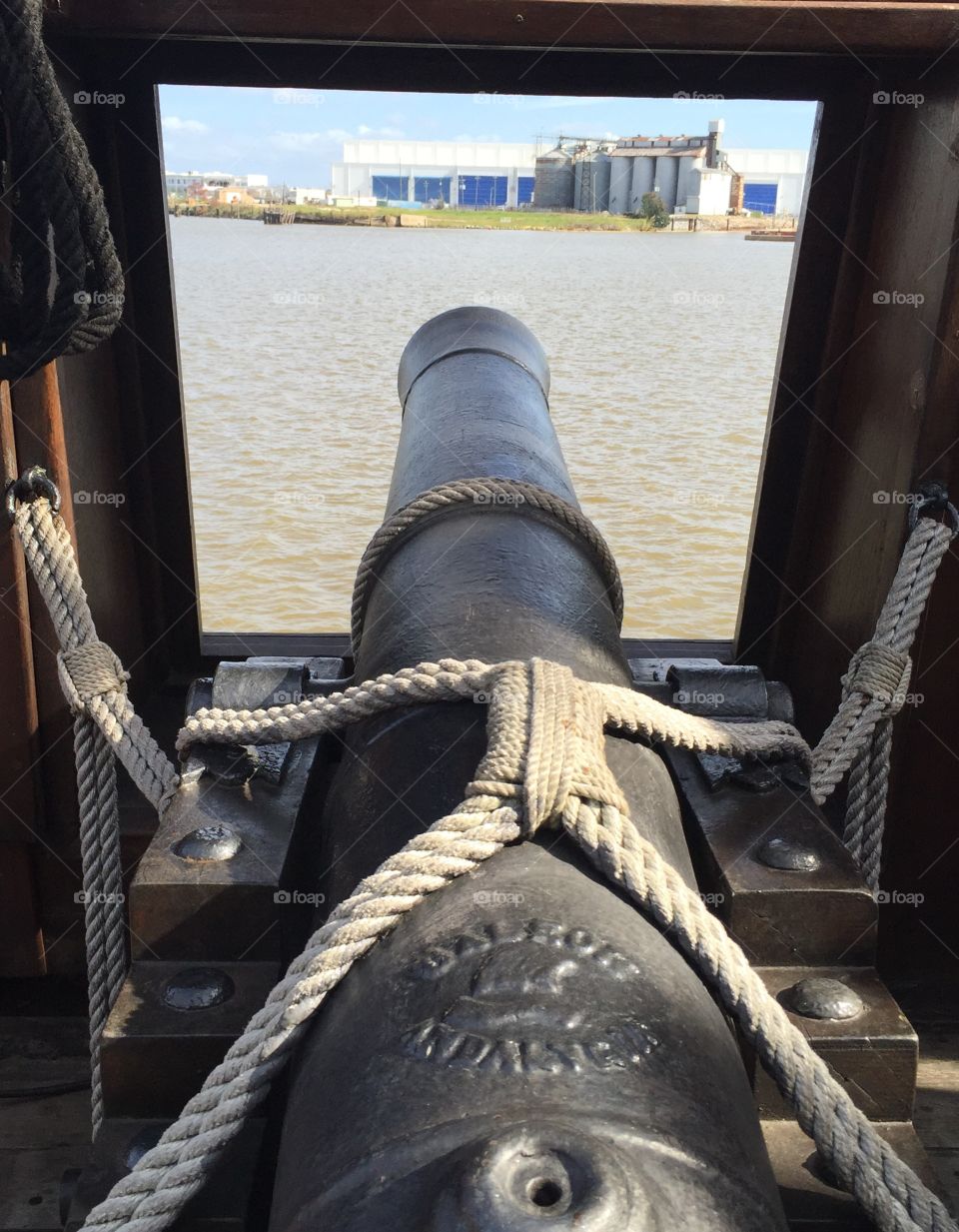 Cast iron canon 18th through the window at the city