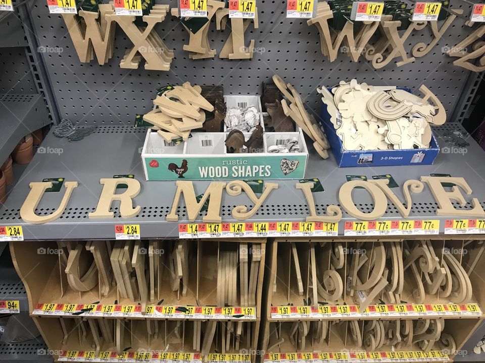 A romantic message spelled out in wooden craft letters during a shopping trip. 