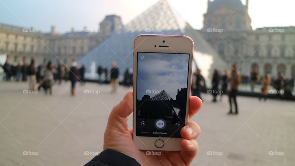 Taking photos in front of the louvre 