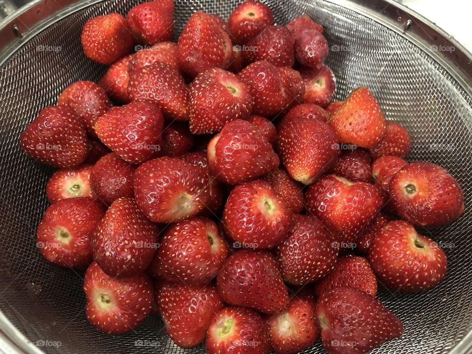Fresh red juicy strawberries that look very appetizing, that has been washed and placed on the grill.